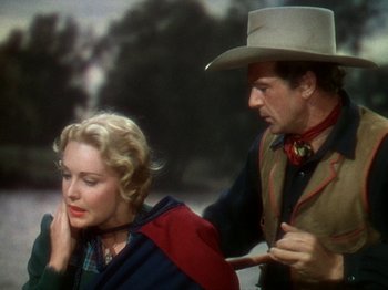 Movie still from “North West Mounted Police” (1940), directed by Cecil B. DeMille – A man and a woman are standing next to each other; Medium shot, Over the shoulder angle