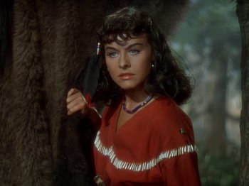 Movie still from “North West Mounted Police” (1940), directed by Cecil B. DeMille – A woman in a red shirt holding a black feather; Close Up shot, Over the shoulder angle