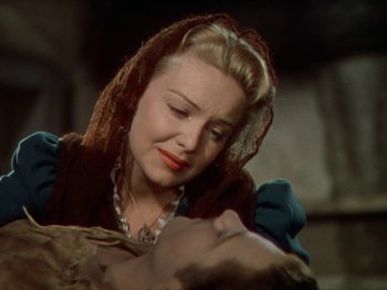 Movie still from “North West Mounted Police” (1940), directed by Cecil B. DeMille – A beautiful woman holding onto a man's chest; Close Up shot, Over the shoulder angle
