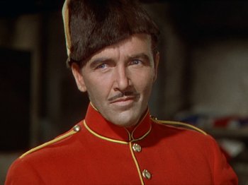 Movie still from “North West Mounted Police” (1940), directed by Cecil B. DeMille – A person wearing a uniform; Close Up shot, Low angle