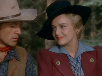Movie still from “North West Mounted Police” (1940), directed by Cecil B. DeMille – A man and a woman in a cowboy hat; Close Up shot, Over the shoulder angle