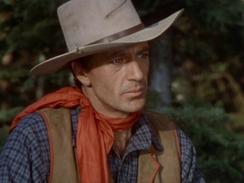 Movie still from “North West Mounted Police” (1940), directed by Cecil B. DeMille – A man wearing a cowboy hat and a vest; Close Up shot, Over the shoulder angle