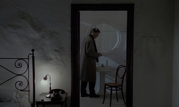 Movie still from “Nostalghia” (1983), directed by Andrei Tarkovsky – A man standing in front of a bathroom sink; Wide shot, High angle