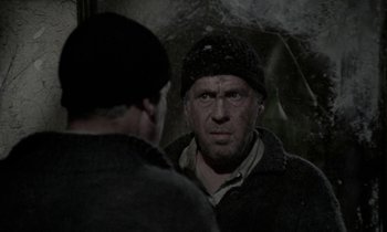 Movie still from “Nostalghia” (1983), directed by Andrei Tarkovsky – A man in a hat looking at a man in a jacket; Close Up shot, Over the shoulder angle