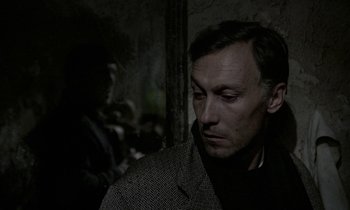 Movie still from “Nostalghia” (1983), directed by Andrei Tarkovsky – A person wearing a jacket; Close Up shot, Over the shoulder angle