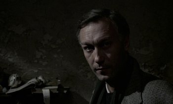 Movie still from “Nostalghia” (1983), directed by Andrei Tarkovsky – A person wearing a jacket; Close Up shot, High angle