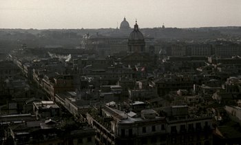 Movie still from “Nostalghia” (1983), directed by Andrei Tarkovsky – An aerial view of a city with a dome church in the background; Extreme Wide shot, High angle