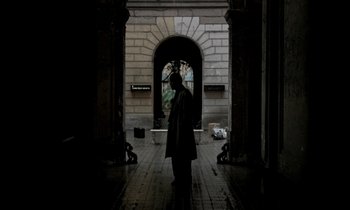 Movie still from “Nostalghia” (1983), directed by Andrei Tarkovsky – A man standing in front of an archway in a building; Wide shot, Low angle