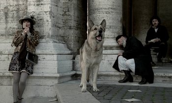 Movie still from “Nostalghia” (1983), directed by Andrei Tarkovsky – A man and a dog in front of pillars; Wide shot, Low angle