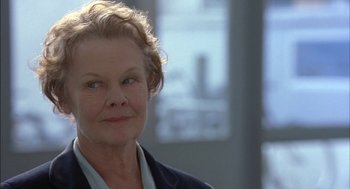 Movie still from “Notes on a Scandal” (2006), directed by Richard Eyre – An older woman is looking into the camera; Close Up shot, Over the shoulder angle