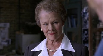 Movie still from “Notes on a Scandal” (2006), directed by Richard Eyre – An older woman wearing a black jacket and a pearl necklace; Close Up shot, Low angle