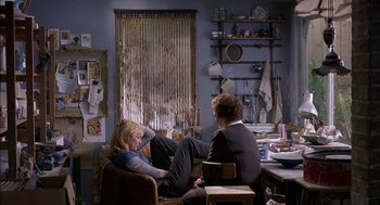 Movie still from “Notes on a Scandal” (2006), directed by Richard Eyre – Two women sitting on a couch in front of a table; Wide shot, Over the shoulder angle
