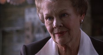 Movie still from “Notes on a Scandal” (2006), directed by Richard Eyre – An older woman is looking into the camera; Close Up shot, Over the shoulder angle