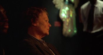 Movie still from “Notes on a Scandal” (2006), directed by Richard Eyre – An older woman sitting in front of a christmas tree; Close Up shot, Over the shoulder angle