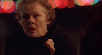Movie still from “Notes on a Scandal” (2006), directed by Richard Eyre – An older woman is looking at the camera; Close Up shot, Low angle