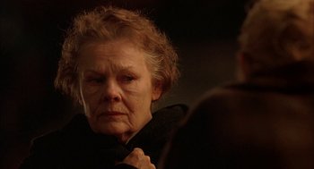 Movie still from “Notes on a Scandal” (2006), directed by Richard Eyre – An older woman looking into a mirror with a sad look on her face; Close Up shot, Over the shoulder angle