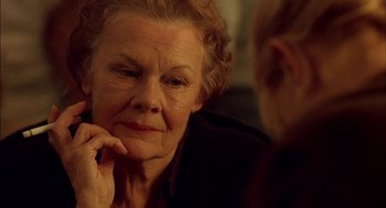 Movie still from “Notes on a Scandal” (2006), directed by Richard Eyre – An older woman sitting in front of another older man; Close Up shot, Over the shoulder angle