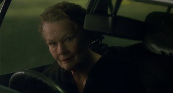Movie still from “Notes on a Scandal” (2006), directed by Richard Eyre – An older woman sitting in the driver's seat of a car; Close Up shot, Over the shoulder angle