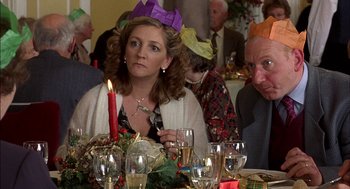 Movie still from “Notes on a Scandal” (2006), directed by Richard Eyre – A group of people sitting at a table with wine glasses; Close Up shot, High angle