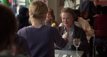 Movie still from “Notes on a Scandal” (2006), directed by Richard Eyre – Two women are sitting at a table with a glass of wine; Medium shot, Over the shoulder angle