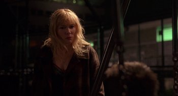Movie still from “Notes on a Scandal” (2006), directed by Richard Eyre – A woman with blonde hair and a brown jacket; Medium shot, Low angle