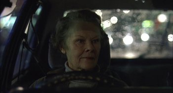 Movie still from “Notes on a Scandal” (2006), directed by Richard Eyre – An older woman sitting in the driver's seat of a car; Close Up shot, Low angle