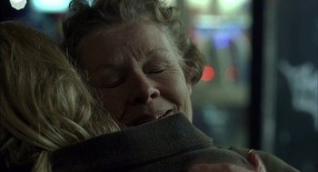 Movie still from “Notes on a Scandal” (2006), directed by Richard Eyre – A person with her eyes closed; Close Up shot, Over the shoulder angle