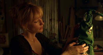 Movie still from “Notes on a Scandal” (2006), directed by Richard Eyre – A woman looking at her cell phone in a dark room; Close Up shot, Low angle
