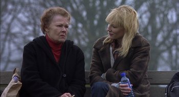 Movie still from “Notes on a Scandal” (2006), directed by Richard Eyre – Two women sitting next to each other on a park bench; Close Up shot, Over the shoulder angle