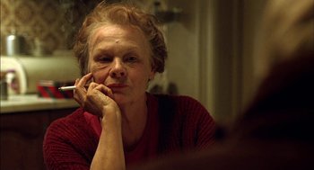 Movie still from “Notes on a Scandal” (2006), directed by Richard Eyre – An older woman sitting in front of a mirror with a cigarette in her mouth; Close Up shot, Over the shoulder angle