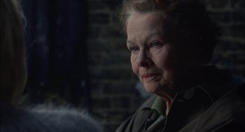 Movie still from “Notes on a Scandal” (2006), directed by Richard Eyre – An older woman is looking at the camera; Close Up shot, Over the shoulder angle