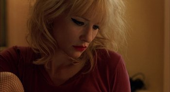 Movie still from “Notes on a Scandal” (2006), directed by Richard Eyre – A woman with blonde hair wearing a red t - shirt; Close Up shot, High angle