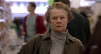 Movie still from “Notes on a Scandal” (2006), directed by Richard Eyre – An older woman is walking down the street; Close Up shot, Low angle