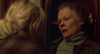 Movie still from “Notes on a Scandal” (2006), directed by Richard Eyre – An older woman sitting next to a younger woman on a train; Close Up shot, Low angle