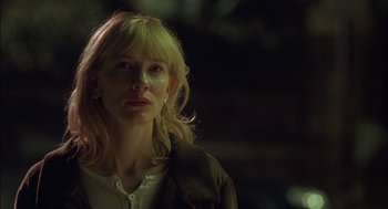 Movie still from “Notes on a Scandal” (2006), directed by Richard Eyre – A woman with blonde hair is standing in the dark; Close Up shot, Low angle