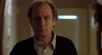 Movie still from “Notes on a Scandal” (2006), directed by Richard Eyre – A person wearing a shirt and jacket; Close Up shot, Low angle