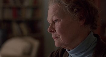 Movie still from “Notes on a Scandal” (2006), directed by Richard Eyre – An older woman looking off into the distance; Close Up shot, Over the shoulder angle