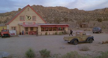 Movie still from “Nothing to Lose” (1997), directed by Steve Oedekerk – An old truck parked in front of a diner in the desert; Extreme Wide shot, High angle