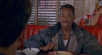 Movie still from “Nothing to Lose” (1997), directed by Steve Oedekerk – A man sitting in front of a plate of food; Close Up shot, High angle