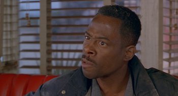 Movie still from “Nothing to Lose” (1997), directed by Steve Oedekerk – A person sitting on a couch; Close Up shot, Over the shoulder angle