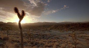 Movie still from “Nothing to Lose” (1997), directed by Steve Oedekerk – The sun is setting over a desert landscape; Extreme Wide shot, Low angle