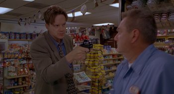 Movie still from “Nothing to Lose” (1997), directed by Steve Oedekerk – A man in a store taking a picture of another man in a store; Medium shot, Low angle