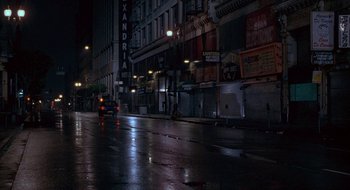 Movie still from “Nothing to Lose” (1997), directed by Steve Oedekerk – A city street at night lit by street lights; Extreme Wide shot, High angle