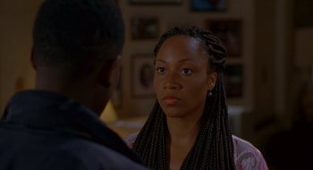 Movie still from “Nothing to Lose” (1997), directed by Steve Oedekerk – A young woman with long braids talking to a young man; Close Up shot, Over the shoulder angle