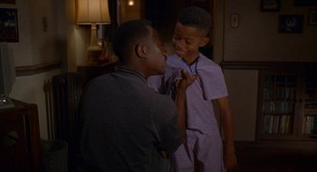 Movie still from “Nothing to Lose” (1997), directed by Steve Oedekerk – Two young boys are playing with each other in a living room; Medium shot, Over the shoulder angle