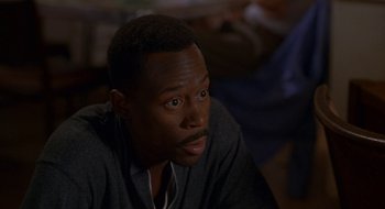 Movie still from “Nothing to Lose” (1997), directed by Steve Oedekerk – A person sitting down with his eyes wide open; Close Up shot, High angle