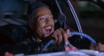 Movie still from “Nothing to Lose” (1997), directed by Steve Oedekerk – A person in a car holding a steering wheel; Close Up shot, Low angle
