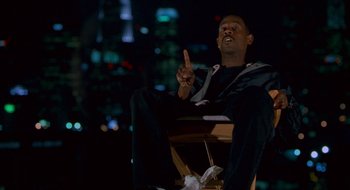 Movie still from “Nothing to Lose” (1997), directed by Steve Oedekerk – A man sitting on a chair in the middle of the night; Medium shot, Low angle