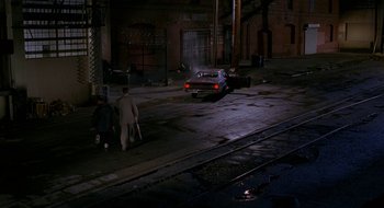 Movie still from “Nothing to Lose” (1997), directed by Steve Oedekerk – A car parked on the side of the road at night; Extreme Wide shot, High angle