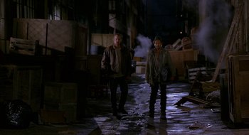 Movie still from “Nothing to Lose” (1997), directed by Steve Oedekerk – A man and a woman walking down a street at night; Wide shot, High angle